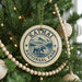 A Christmas tree decorated with ornaments, including a circular ornament with the text "KATMAI NATIONAL PARK USA" and a bear illustration.