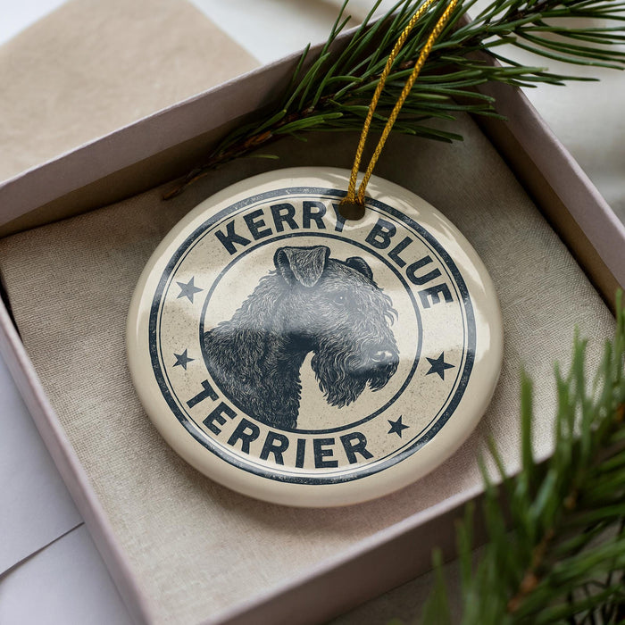 A ceramic ornament in a box, featuring a black and white illustration of a terrier dog with the text "KERRY BLUE TERRIER" around the edge.