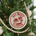 A Christmas tree decorated with ornaments, including a circular ornament with the text "KEY WEST FLORIDA USA" and a palm tree design.