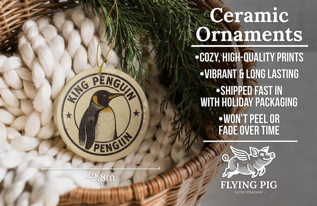 Ceramic ornaments, featuring a King Penguin ornament, are displayed in a wicker basket.