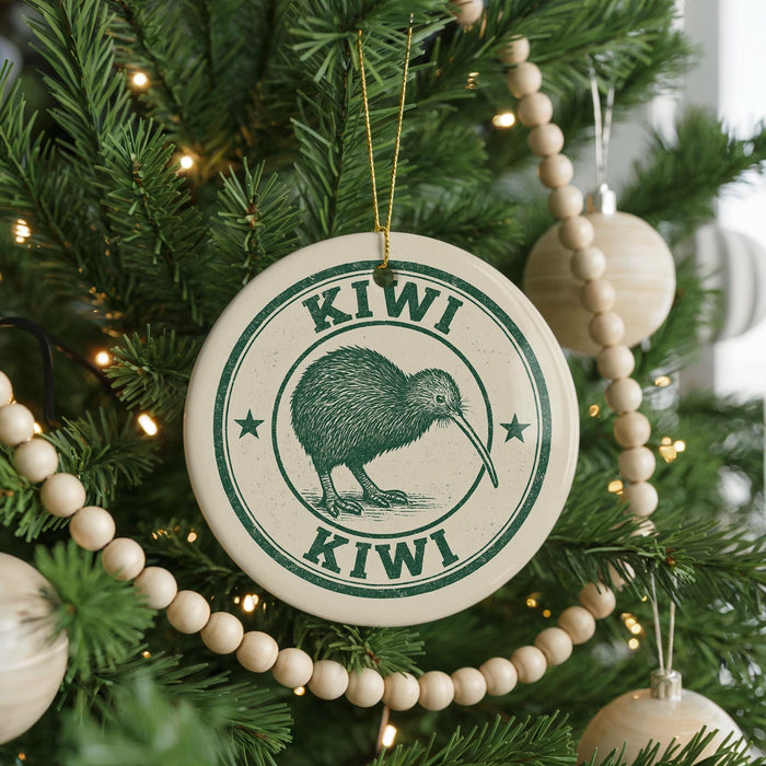 A Christmas tree decorated with ornaments, including a circular ornament with a kiwi bird design and the text "KIWI" around the edge.