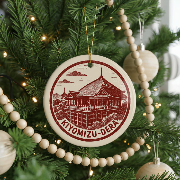 A Christmas tree decorated with ornaments, including a circular ornament with a red and white design depicting the Kiyomizu-Dera temple in Kyoto, Japan.