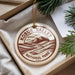 A circular ornament with the text "KOBUK VALLEY NATIONAL PARK USA" printed on it, hanging from a string.