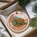 A circular ornament with a komodo lopus ( Komodo dragon) design, surrounded by text that reads "KOMODO NATIONAL PARK INDONESIA".