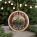 A circular ornament with a picture of Lake Bled and the text "Lake Bled Slovenia" on it, hanging from a string.