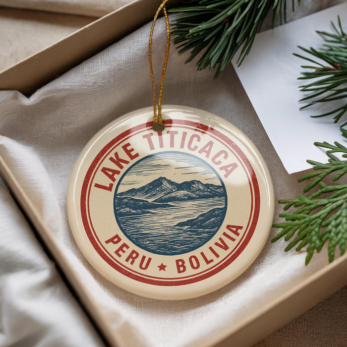 A circular ornament with a red border and a graphic of a mountain range, surrounded by text that says "LAKETITICA PERU BOLIVIA".