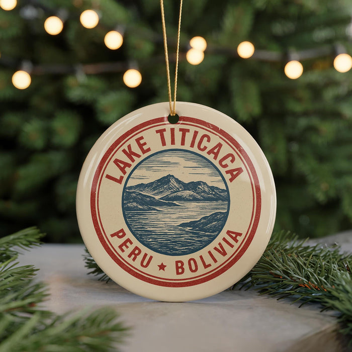 A circular ornament with a red border and a graphic of a mountain and lake, surrounded by the text "LAKE TITICACA PERU BOLIVIA".
