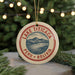 A circular ornament with a red border and a graphic of a mountain and lake, surrounded by the text "LAKE TITICACA PERU BOLIVIA".
