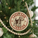 A circular ornament on a Christmas tree, featuring a terrier dog and the text "LAKELAND TERRIER".