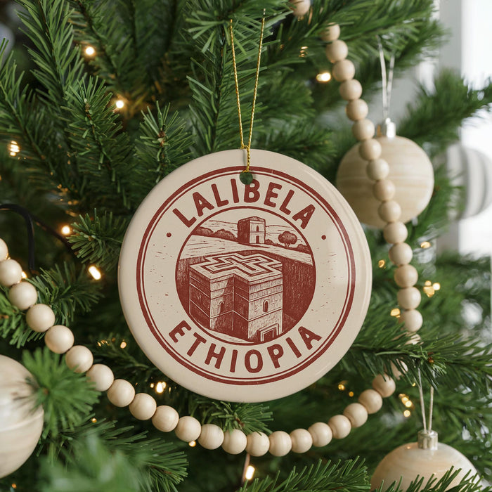 A circular ornament on a Christmas tree, featuring the text "LALIBEZA" and "ETHIOPIA" in red and white, along with an illustration of a building.