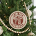 A circular ornament on a Christmas tree, featuring the text "LALIBEZA" and "ETHIOPIA" in red and white, along with an illustration of a building.
