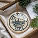 A circular ornament with the text "LAS PALMAS" and "SPAIN" printed on it, surrounded by a decorative border.
