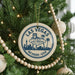 A circular ornament on a Christmas tree, featuring the text "Las Vegas, Nevada, USA" and the Las Vegas skyline silhouette.