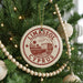A Christmas tree decorated with ornaments, including a circular ornament with the text "LIMASSOL CYPRUS" and a palm tree illustration.
