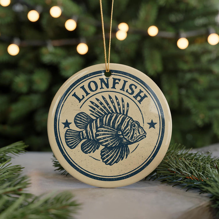 A circular ornament with the word "LIONFISH" and a graphic of a lionfish is displayed on a table, surrounded by pine branches and twinkling lights.
