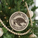 A Christmas tree decorated with a circular ornament featuring a turtle and the text "Loggerhead Turtle" and "Caretta Caretta".