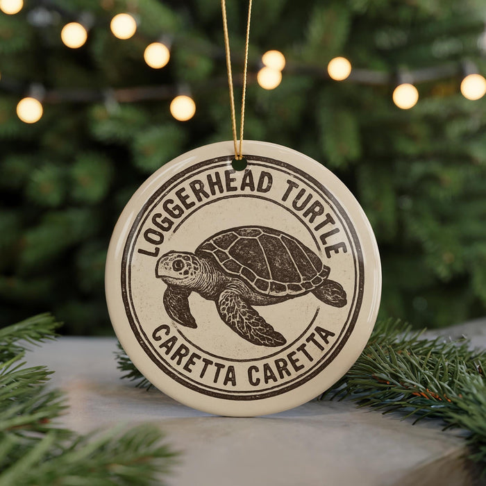 A circular ornament featuring a turtle design, with the text "Loggerhead Turtle" and "Caretta Caretta" printed on it.