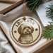 A circular ornament featuring a dog's portrait, with the text "LÖWCHEN" prominently displayed.