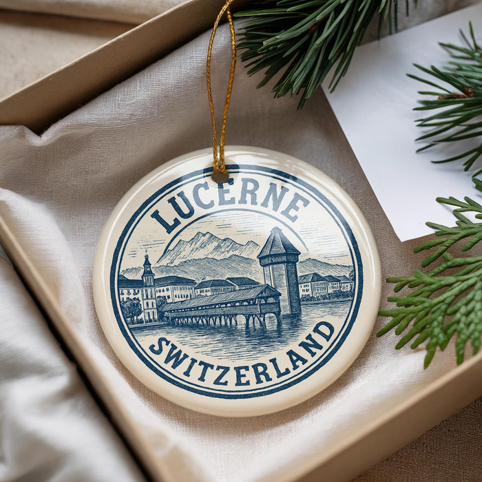 A decorative ornament with the text "LUCERNE SWITZERLAND" and an illustration of a Swiss town, hanging from a string.