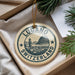 A circular ornament with the text "LUCANO SWITZERLAND" and a graphic of a Swiss mountain, hanging from a string.
