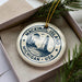 A circular ornament with the text "Mackinac Island, Michigan, USA" printed on it, surrounded by pine branches.