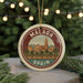 A circular ornament with the text "MALAGA SPAIN" and an illustration of a cityscape, likely representing the city of Malaga, Spain.