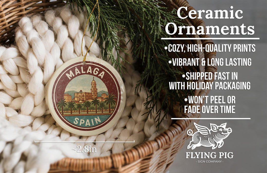 a ceramic ornament with a design of a cityscape, specifically Malaga, Spain, hanging from a wicker basket. The ornament is described as a "Ceramic Ornaments" and is made of high-quality materials, with a vibrant and long-lasting design. It is also shipped fast and comes with holiday packaging, and it is not likely to peel or fade over time. The image is a close-up of the ornament, and there is a scale indicating its size, with the text "2.8in" visible.
