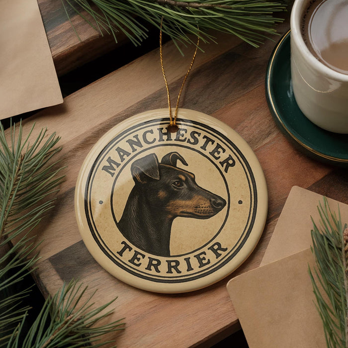 A round ornament featuring a Manchester Terrier dog's head, with the text "MANCHESTER TERRIER" around the edge.