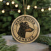 A circular ornament featuring a close-up of a Manchester Terrier dog's head, with the text "MANCHESTER TERRIER" prominently displayed.