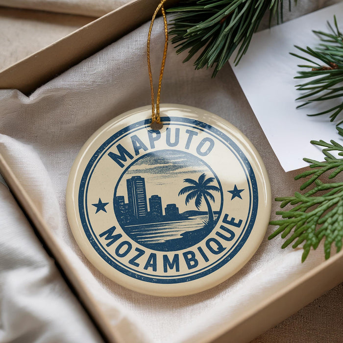 A circular ornament with the text "Mazuto Mozambique" printed on it, hanging from a string.