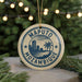 A circular ornament with the text "MAPUTO MOZAMBIQUE" and a graphic of a city skyline, surrounded by Christmas lights and greenery.