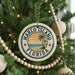 A Christmas tree decorated with ornaments, including a circular ornament with the text "MARCO ISLAND FLORIDA" and a palm tree design.