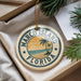 A round ornament with the text "MARCO ISLAND FLORIDA" and a palm tree design, hanging from a string.