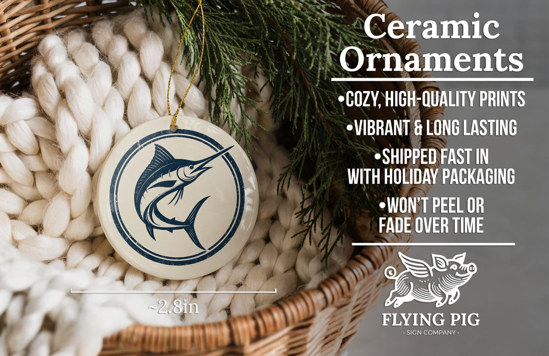 Ceramic ornaments, featuring a blue and white design of a swordfish, are displayed in a woven basket.