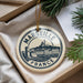 A circular ornament with the text "MARSEILLE FRANCE" and an illustration of a cityscape, hanging from a string.