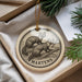 A circular ornament featuring a drawing of two martens climbing a tree, with the word "MARTENS" written below the image.