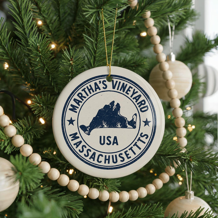 A Christmas tree decorated with ornaments, including a circular ornament with the text " Martha's Vineyard USA" and a silhouette of a person.
