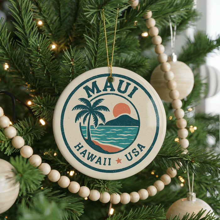 A circular ornament on a Christmas tree with the text "MAUI HAWAII USA" and a palm tree design.