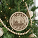 A Christmas tree decorated with ornaments, including a circular ornament with the text "MEDINA SAUDI ARABIA" and a mosque illustration.