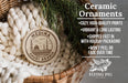 Ceramic ornaments, featuring a round ornament with a design of a mosque and the word 'MEDINA' in the center, hanging from a wicker basket.