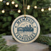 A circular ornament with the text "MEMPHIS TENNESSEE USA" and a graphic of a bridge and skyline, hanging from a string.
