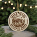 A circular ornament with the text "MESA VERDE NATIONAL PARK USA" printed on it, hanging from a string.
