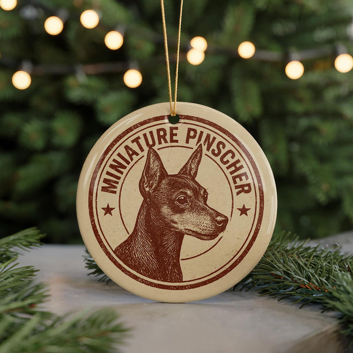 A round ornament featuring a miniature pinscher dog, with the text "MINIATURE PINSCHER" printed on it.