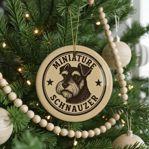 A round ornament with a dog's head and the text "MINIATURE SCHNAUZER" is hanging on a Christmas tree.