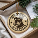 A round ornament with a dog's head and the text "MINIATURE SCHNAUZER" printed on it, hanging from a string.