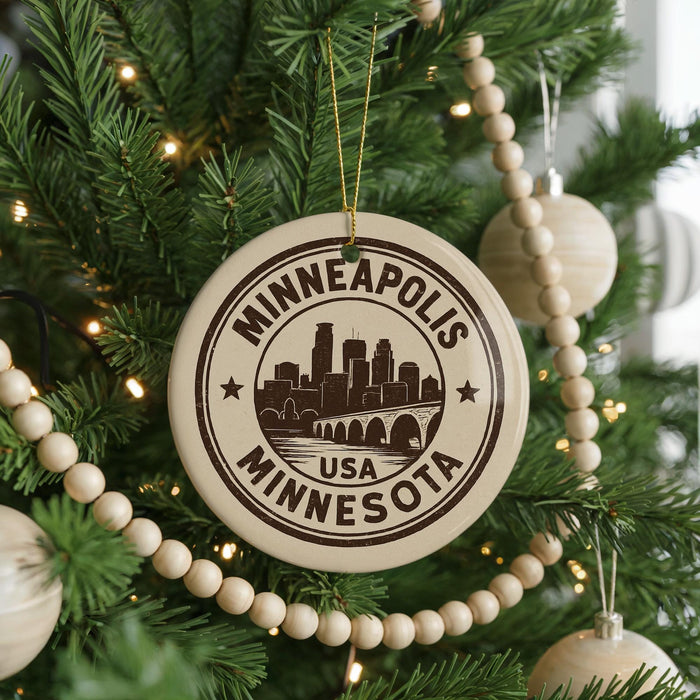 A Christmas tree decorated with ornaments, including a circular ornament with the text "MINNEAPOLIS USA MINNESOTA" and a silhouette of a city skyline.
