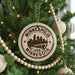 A Christmas tree decorated with ornaments, including a circular ornament with the text "MINNEAPOLIS USA MINNESOTA" and a silhouette of a city skyline.