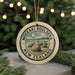 A circular ornament with the text "MOERAKI BOULDERS NEW ZEALAND" and an illustration of a rocky landscape, hanging from a string.