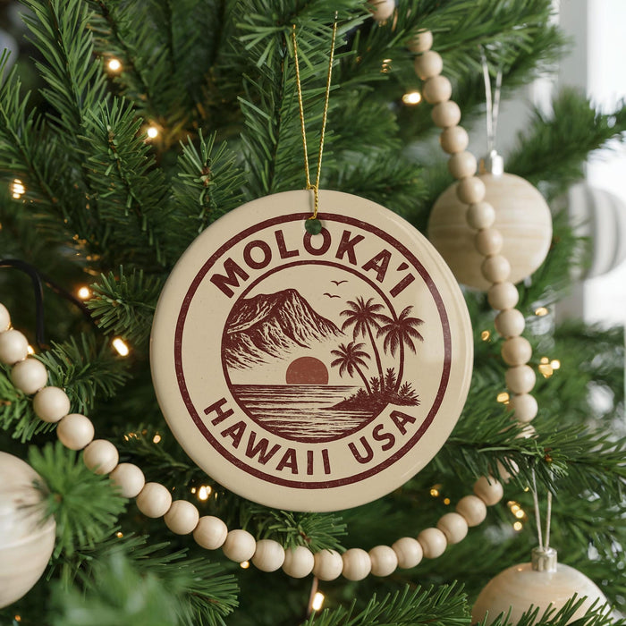 A round ornament on a Christmas tree with the text "MOLOKAI'I HAWAII USA" printed on it.