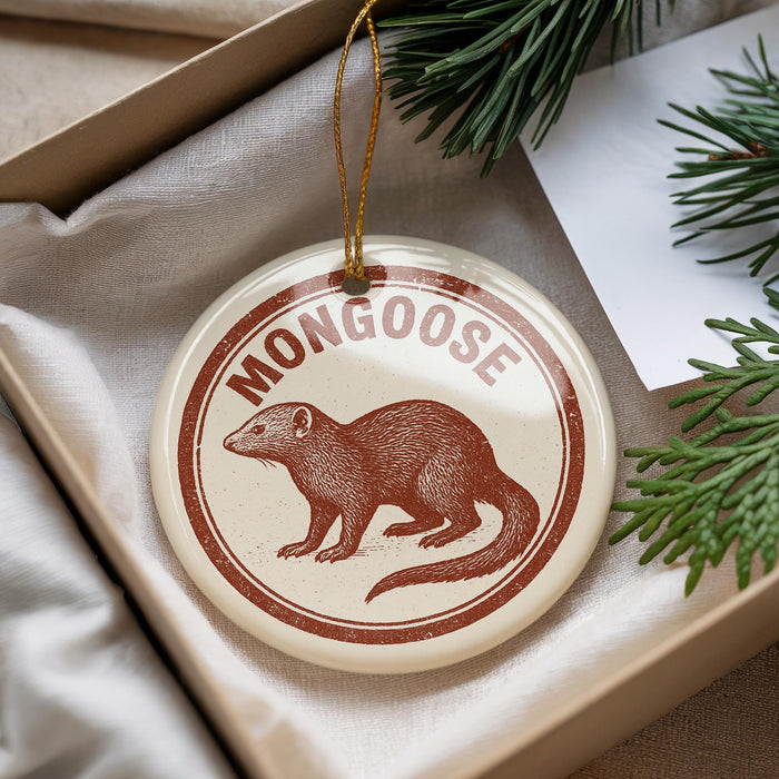A round ornament with a brown moose illustration and the word "MONGOOSE" printed on it, hanging from a string.